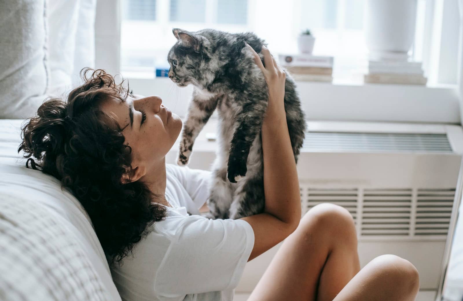 Content woman with cat at home